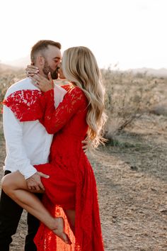 a man and woman kissing in the desert