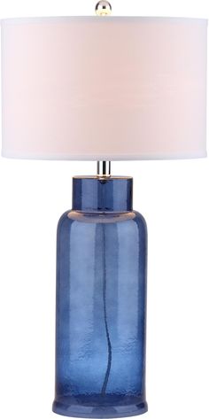 a blue glass table lamp with a white shade on the top and bottom part of it