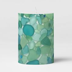 a candle with sea glass on it