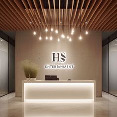 the front desk of a hotel lobby with lights on and wood slats above it