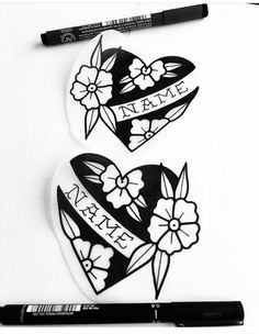 two heart shaped magnets with name and flowers on them next to a marker pen