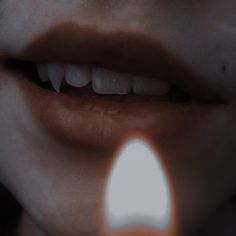 a woman's mouth with a light coming out of the lip to show her teeth