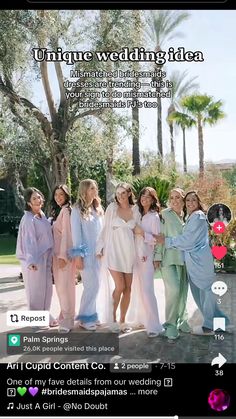 a group of women standing next to each other in front of trees and palm trees