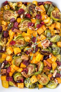 roasted brussel sprouts with cranberries and pecans in a white casserole dish