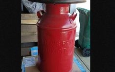 a large red fire hydrant sitting on top of a pallet