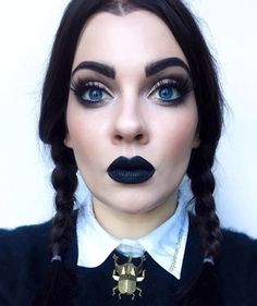 a woman with black lipstick and spider costume