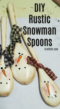 three wooden spoons with snowmen painted on them and the words diy rustic snowman spoons