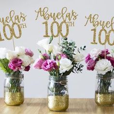 three mason jars with flowers in them on a table