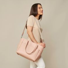 This structured tote is the ultimate do-it-all bag that you deserve. It's the perfect carryall for work, travel, and anywhere your day brings you. It features a spacious and organized interior for your essentials, a padded compartment for your laptop, side pockets for your drinks, and you can convert it into a backpack or crossbody. Crafted from premium American Saffiano leather that's waterproof and scratch-resistant, the Transform Tote will stay just as beautiful through all your travels and a Modern Diaper Bag With Adjustable Strap For On-the-go, On-the-go Laptop Bag With Detachable Double Handle, Chic Tote Laptop Bag For On-the-go, Chic On-the-go Diaper Bag With Double Handle, On-the-go Tote Briefcase With Detachable Handle, Chic Rectangular Laptop Bag For On-the-go, Modern Travel Bag With Detachable Double Handle, Versatile Top Handle Laptop Bag With Removable Pouch, Modern Weekender Bag With Detachable Double Handle