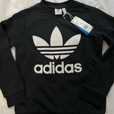 Brand New Adidas Pullover. Size Medium Basic Adidas Logo Crew Neck Tops, Basic Adidas Crew Neck Tops, Basic Winter Tops With Logo Print, Adidas Logo Print Tops For Fall, Adidas Logo Tops For Streetwear In Fall, Adidas Logo Tops For Fall Streetwear, Adidas Logo Sweatshirt With Crew Neck For Fall, Adidas Long Sleeve Top With Logo Print, Adidas Tops With Ribbed Cuffs For Streetwear