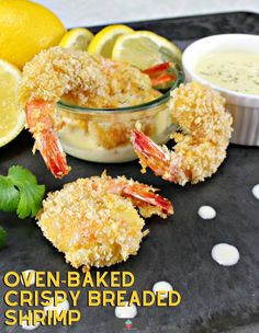 some food is sitting on a tray with lemons and parsley in the background