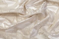 This brocade has a heavy weight and a stiff drape. Elegant Satin Finish Fabric For Wedding, Elegant Wedding Fabric With Satin Finish, Elegant Satin Fabric For Wedding, Elegant Wedding Satin Fabric, Elegant Beige Fabric For Wedding, Elegant Beige Wedding Fabric, Cream Silk Fabric For Wedding, Elegant Jacquard Fabric For Evening, Elegant Cream Fabric For Wedding