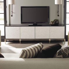 a living room scene with focus on the entertainment center and large screen tv in the background