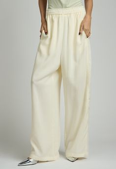 One size. Fits XS-MColor: CreamLightweight FabricDrawstring Waist100% TencelDry Clean By The NKC StoreProduct Measurements:Waist: 66.04cm / 26in Length: 104.77cm / 41.25in Silk Wide-leg Daywear Pants, Silk Wide-leg Pants For Daywear, High-waisted Silk Bottoms With Elastic Waistband, Silk Bottoms With Elastic Waistband And Straight Leg, High-waisted Silk Pants With Elastic Waistband, Silk High-waisted Bottoms With Elastic Waistband, Silk High-waisted Pants With Elastic Waistband, Casual Silk High-waisted Pants, Casual High-waisted Silk Pants