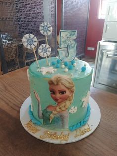 a frozen princess birthday cake on a table