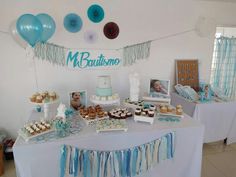 a table topped with cakes and cupcakes next to balloons