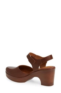 A woodgrain platform heel on a clog-inspired pump brings retro style to your ensembles. 3" heel Round toe Adjustable slingback strap with buckle closure Cushioned footbed Synthetic upper and lining, rubber sole Imported Brown Slingback Pumps With Stacked Heel And Ankle Strap, Leather Wedge Heel Clogs With Buckle Closure, Brown Wedge Heel Clogs With Buckle Closure, Brown Slingback Pumps With Buckle Closure And Round Toe, Brown Slingback Clogs With Wooden Heel, Brown Clogs With Heel Loop And Ankle Strap, Brown Ankle Strap Platform Clogs, Brown Platform Slingback Pumps With Open Heel, Brown Slingback Pumps With Ankle Strap And Platform