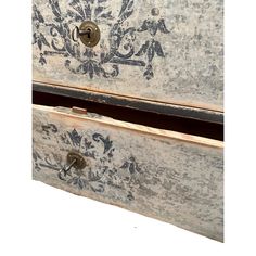 an old dresser with ornate designs painted on it's doors and drawer handles, is shown against a white background