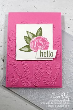 a close up of a pink card with a flower on the front and words that say hello