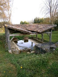 an old water well in the middle of a field