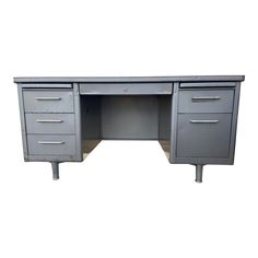 an office desk with two drawers and one drawer on the bottom, is shown in grey