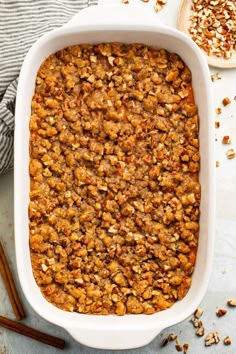 a white casserole dish filled with bread and nuts