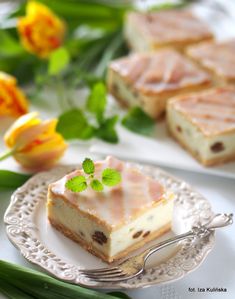 there are two slices of cake on the plate with green garnish and leaves