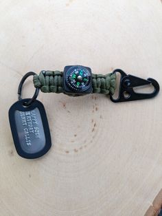 a watch on a lanyard with a keychain and tag attached to it