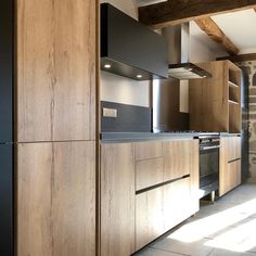 a kitchen with wooden cabinets and black appliances