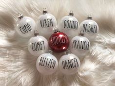 six glass ornaments with words written on them