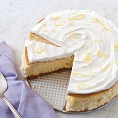 a cake with white frosting and yellow sprinkles sits on a plate