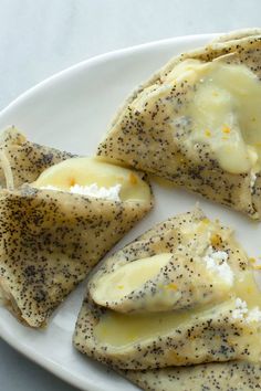 three pieces of food on a plate with seasoning sprinkled over them and cheese in the middle