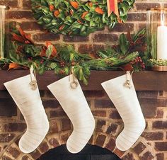 three stockings hanging from a mantel over a fireplace