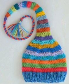 a multicolored knitted hat with a tassel