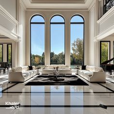 an elegant living room with large windows and marble flooring