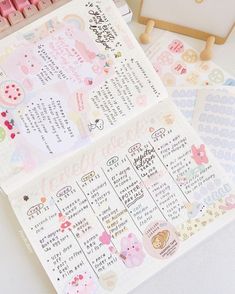 two planner pages with stickers on them next to a keyboard