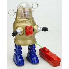 a toy robot that is next to a red object