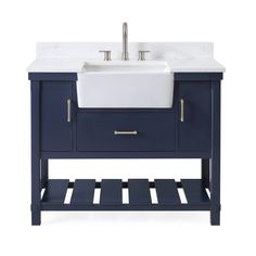 a white sink sitting next to a blue stand with drawers and a faucet