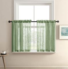 a window with a green curtain hanging from it's side