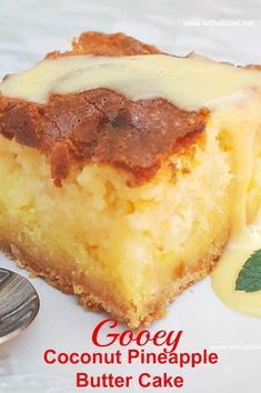 a piece of coconut pineapple butter cake on a white plate next to a spoon