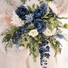 a bridal holding a bouquet of blue and white flowers