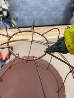 the wire is being used to make a vase