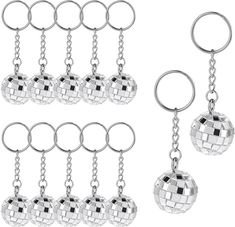 four silver key chains with disco balls hanging from the ends, all in different shapes and sizes