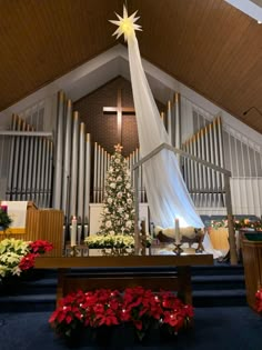 the interior of a church decorated with flowers and christmas decorations, including a large star