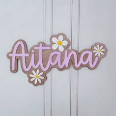 a wooden sign that says atlanta with daisies