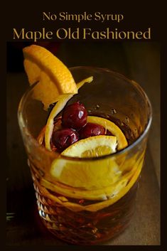 an old fashioned drink is garnished with cherries and lemon wedges