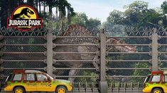 two cars parked in front of a fence with an image of a dinosaur on it