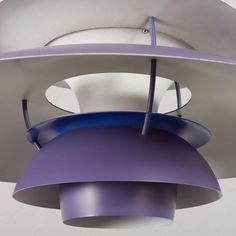 a purple and white light hanging from the ceiling