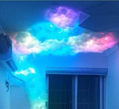 a room that has some lights on the ceiling and clouds painted on the wall above it