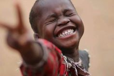 a young boy making the peace sign with his hands